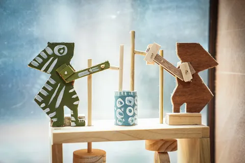 Wooden animal toys on a sunny windowsill