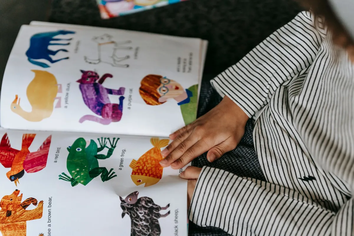 A child reading an open book, seen from above