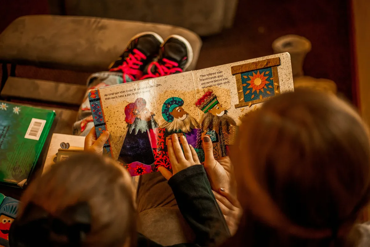 Children gathered around an open illustrated picture book