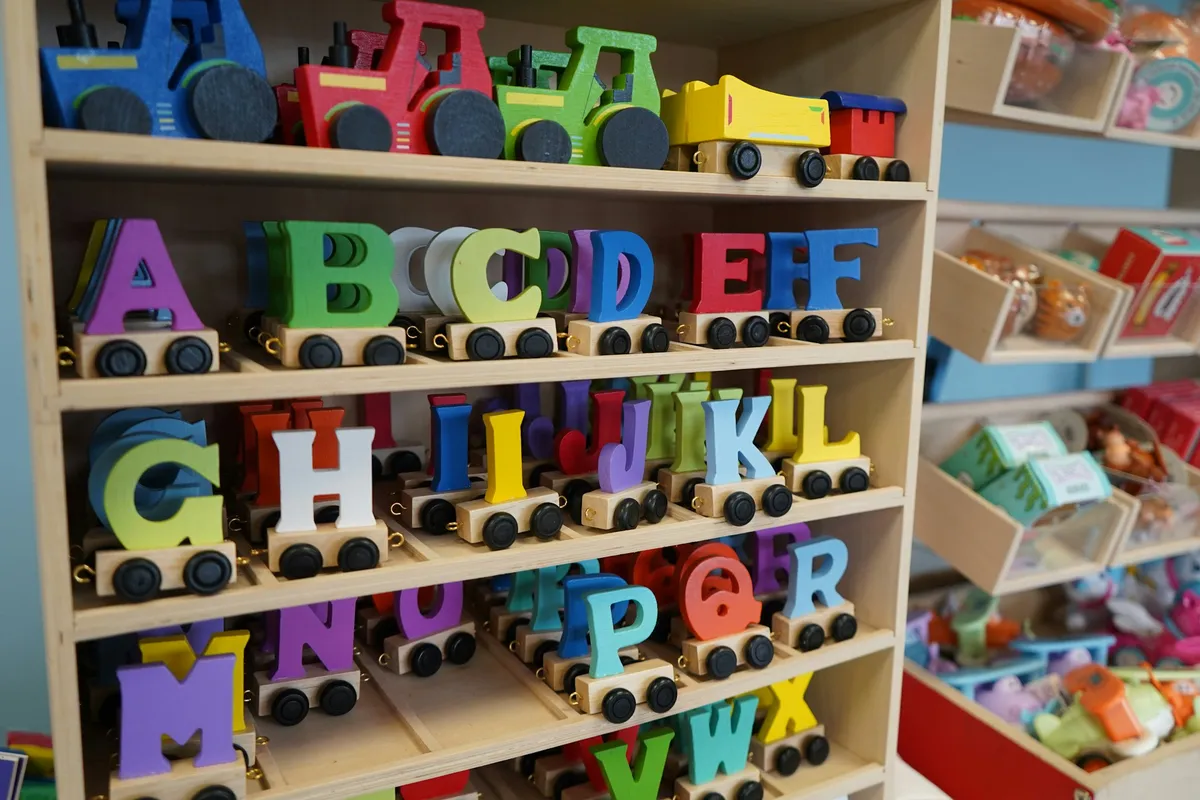 Colorful wooden alphabet toy trains on a shelf
