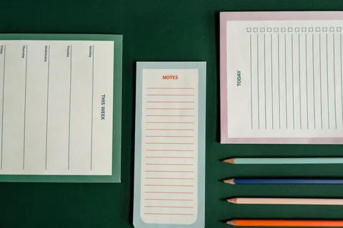 Notebooks and pencils arranged for planning, seen from above