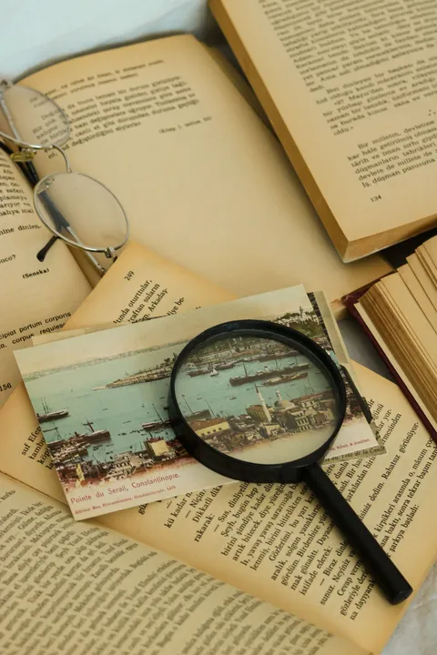 A magnifying glass resting on open books