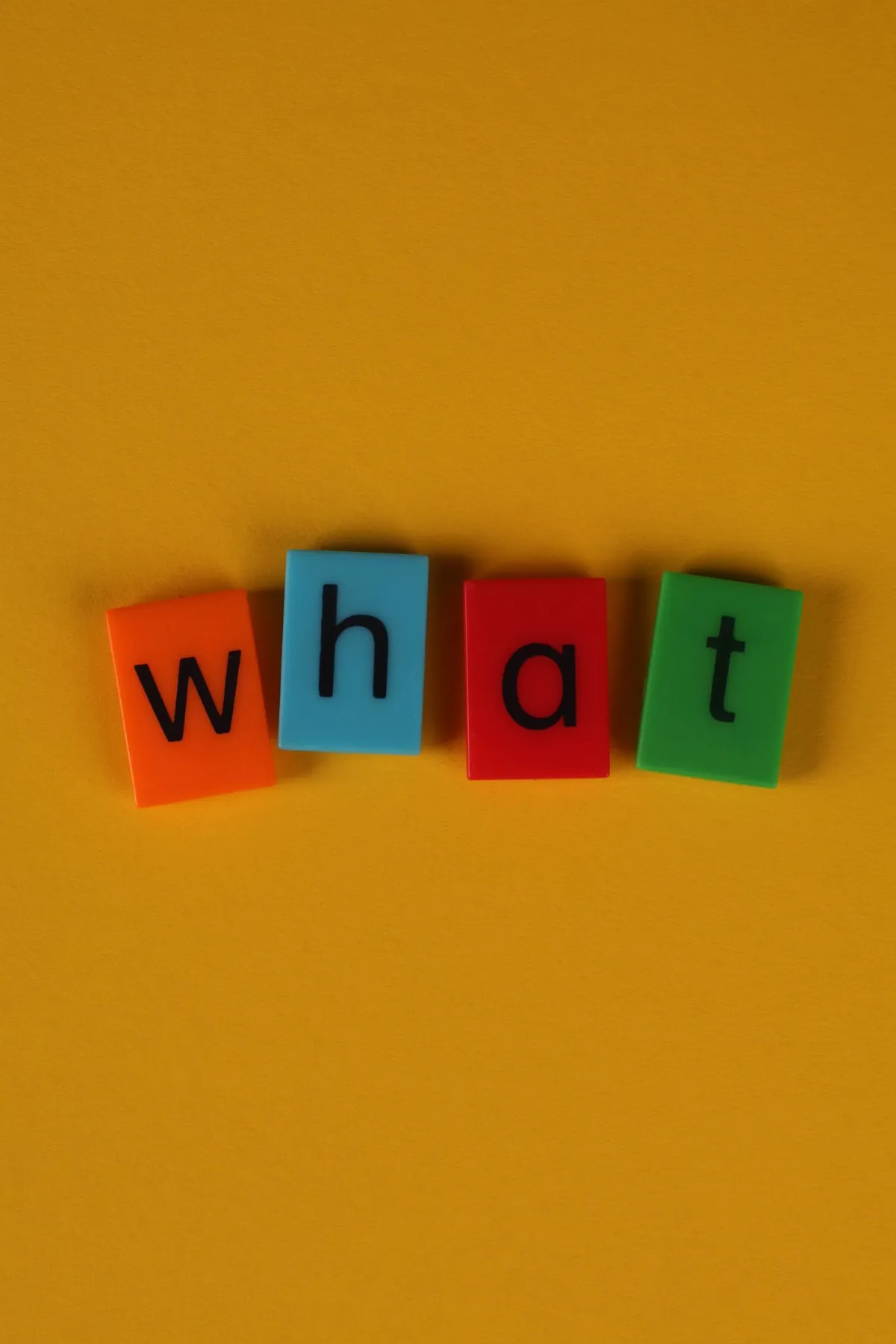 Colorful letter blocks spelling a word on a yellow background