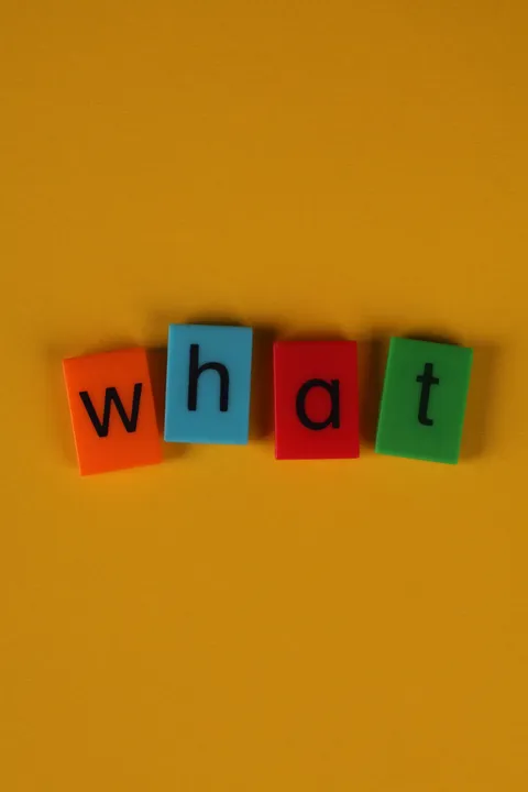 Colorful letter blocks spelling a word on a yellow background