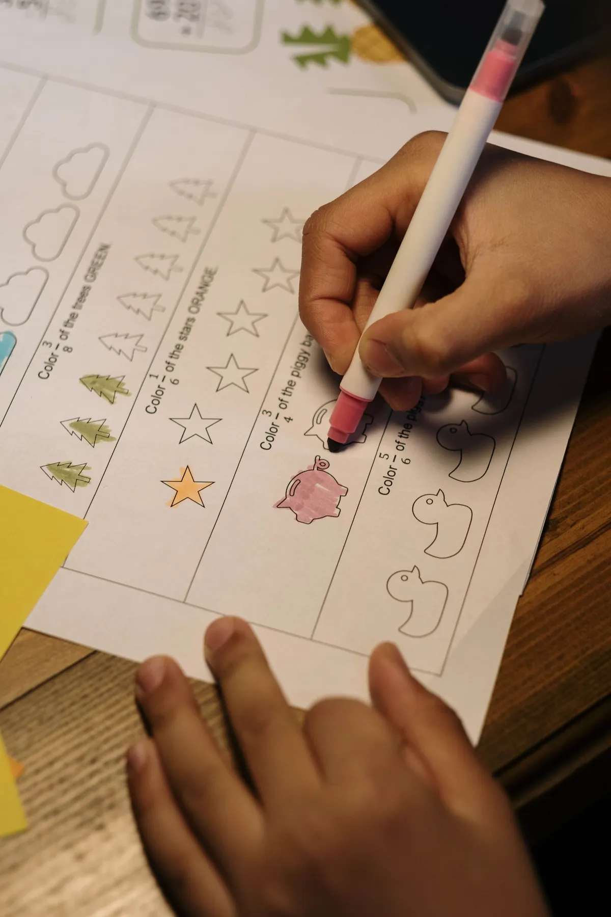 A child coloring shapes in a homeschool activity