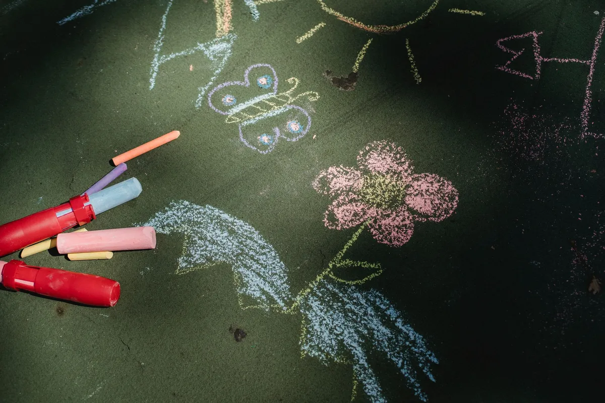 Bright chalk drawings on green pavement
