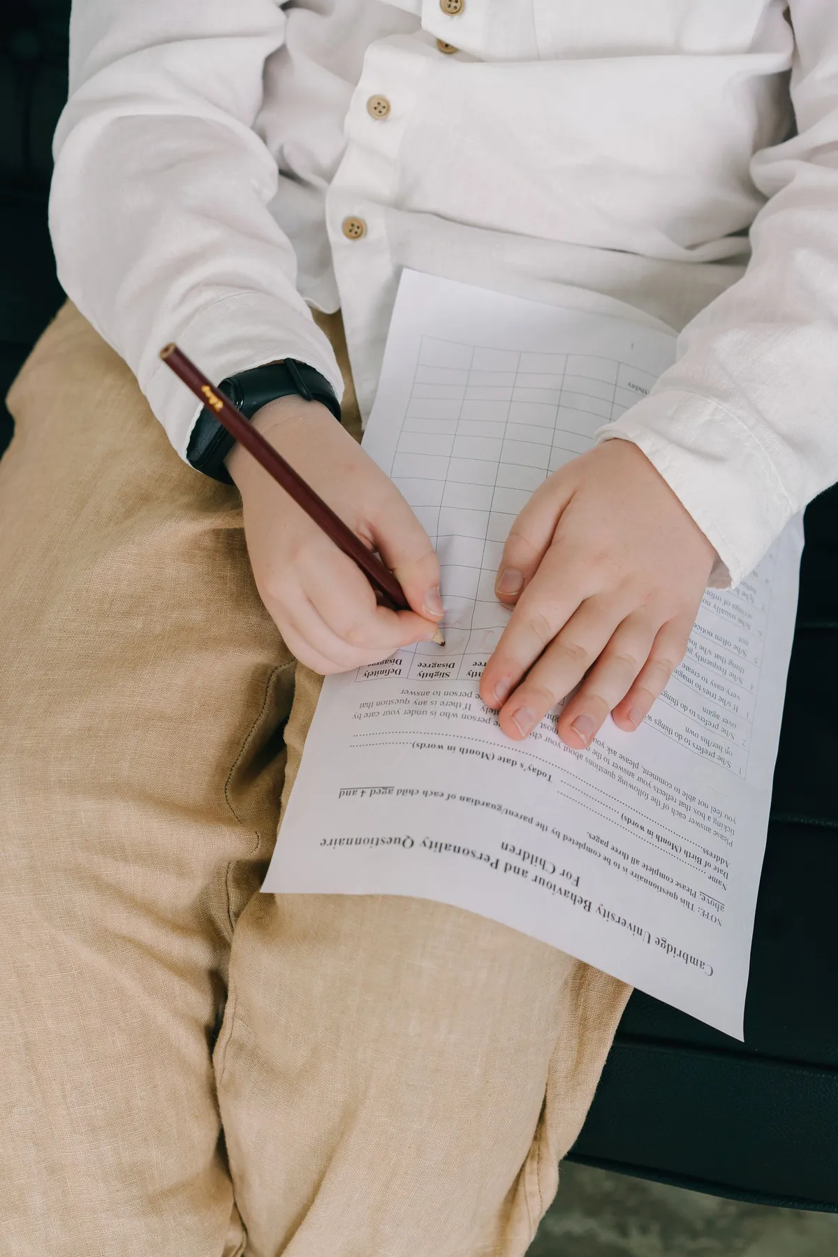 Hands filling in a printed worksheet