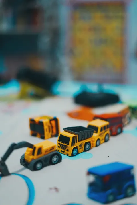 Toy construction trucks on a play mat